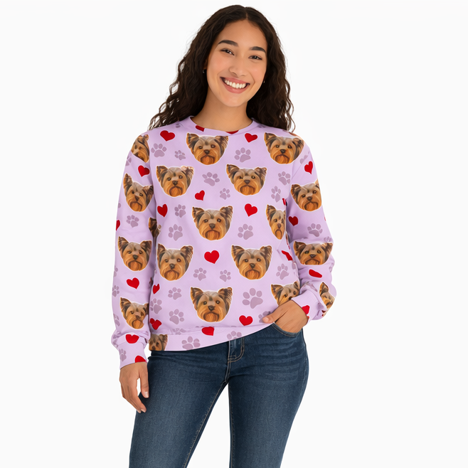 Woman wearing a pink sweater with dog pattern and blue jeans on a white background